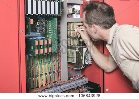 machinist worker technicians at work adjusting lift with spanner