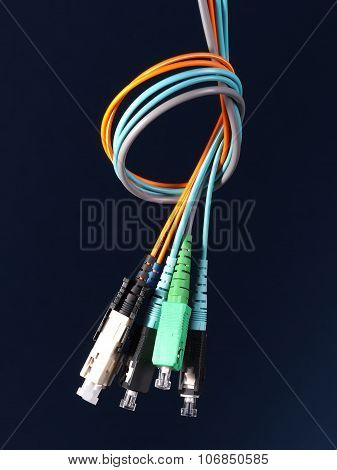 Bundle of three fiber optic patch cords with connectors arranged in a knot