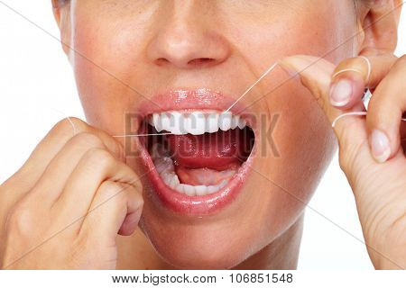 Woman teeth with dental floss. Dentistry health care.