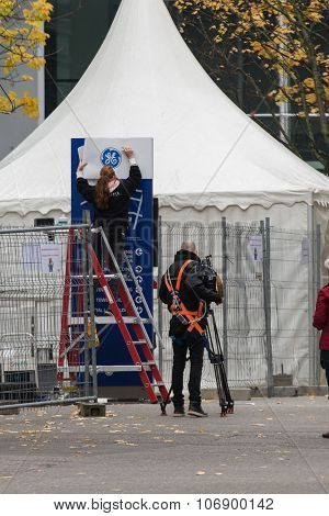 BADEN, SWITZERLAND. November 2nd, 2015. Alstom logos being removed by worker to install GE logos for merger and acquisition of General Electric.