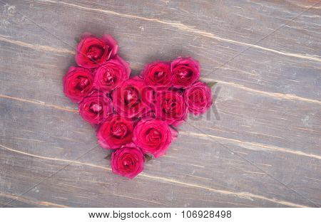 Heart Fromm Flowers On The Wooden Background