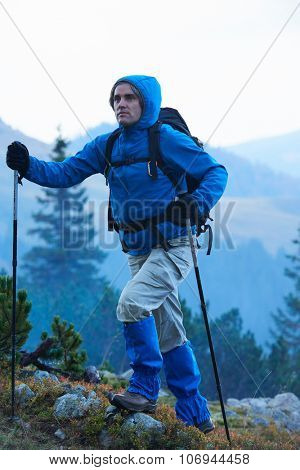 advanture man with backpack hiking on mountain forest