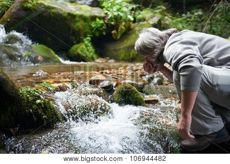 advanture man with backpack hiking on mountain forest