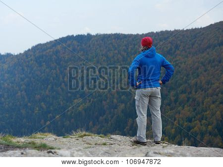 advanture man with backpack hiking on mountain forest
