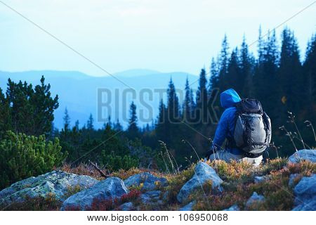 advanture man with backpack hiking on mountain forest