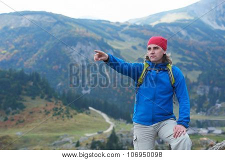 advanture man with backpack hiking on mountain forest