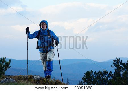 advanture man with backpack hiking on mountain forest