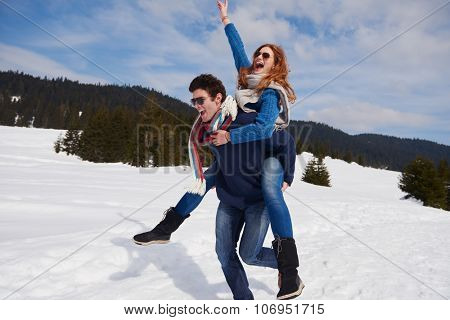 romantic winter  scene, happy young couple having fun on fresh show on winter vacatio, mountain nature landscape