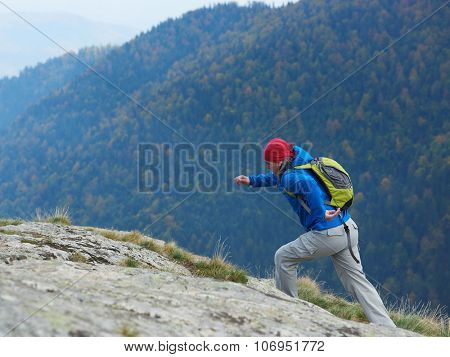 advanture man with backpack hiking on mountain forest