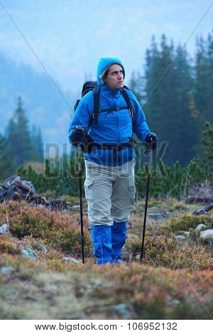 advanture man with backpack hiking on mountain forest