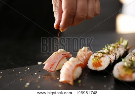 Classic thick rolls futomaki served on a stone plate