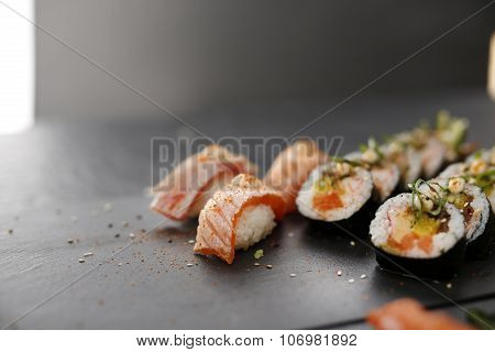Classic thick rolls futomaki served on a stone plate