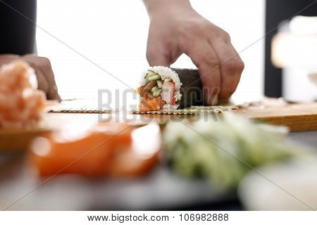 Sushi master turns sushi rolls