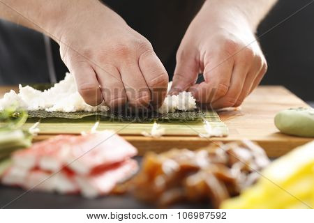 Sushi master preparing sushi in Japanese restaurant