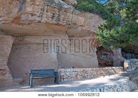 Bench under massive limestone rock