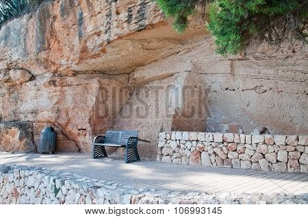 Bench under massive limestone rock