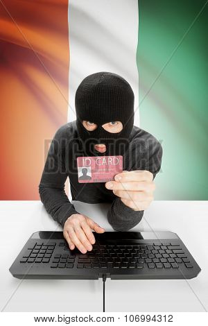 Hacker With Flag On Background Holding Id Card In Hand - Ivory Coast