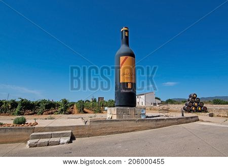 MALLORCA SPAIN - AUGUST 7 2017: Large bottle landmark in the Jose L. Ferrer vineyard on a sunny day on August 7 2017 in Mallorca Spain.