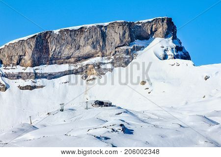 Snow mountains winter landscape at Ifen ski resort. Mountain station hut with ski slope and cablecar. Bavaria, Germany.
