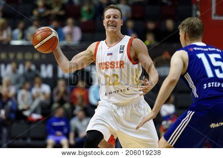 ST. PETERSBURG, RUSSIA - AUGUST 4, 2017: Dmitry Kulagin in action in the basketball match Russia (white) vs Finland (blue) during Kondrashin-Belov Cup. Russia won 91:75