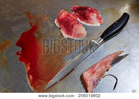 Amberjack fish cheeks fillet process on stainless steel kitchen