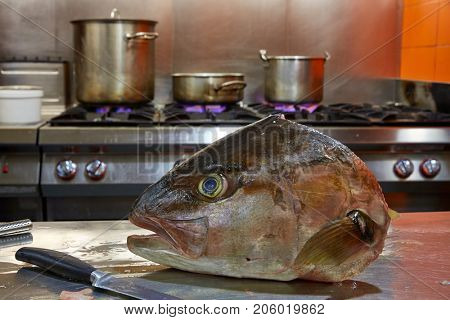 Amberjack fish head fillet process in stainless steel kitchen