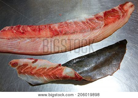Amberjack fish fillet process in stainless steel kitchen