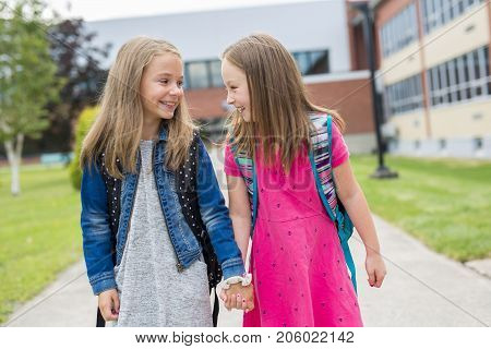 The Great Portrait Of School Pupil Outside Classroom Carrying Bags