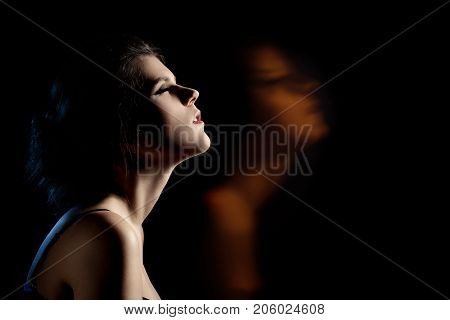 sensual dreaming woman in enjoyment at dark