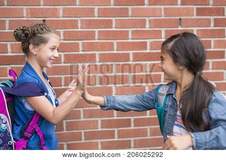 The Great Portrait Of School Pupil Outside Classroom Carrying Bags