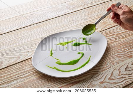 Modern cuisine chef preparation with creamy spots Molecular gastonomy