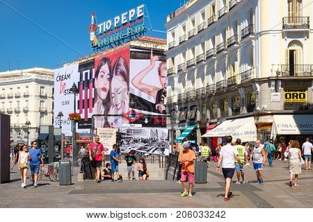 MADRID,SPAIN - AUGUST 5,2017 : Tourists and locals at Puerta del Sol, one of the busiest and most well known places in Madrid