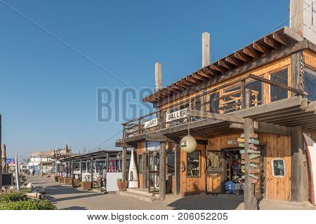 WALVIS BAY NAMIBIA - JULY 1 2017: An art gallery restaurant and other businesses at the watefront in Walvis Bay on the Atlantic Coast of Namibia