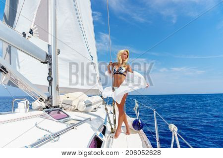 woman relaxing on a cruise boat wearing white tunic