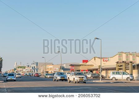 WALVIS BAY NAMIBIA - JULY 1 2017: A late afternoon street scene with businesses and vehicles in Walvis Bay on the Atlantic Coast of Namibia