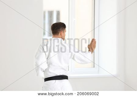 Man practicing karate indoors