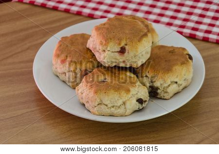 A plate of traditional English fruit and cherry scones scones