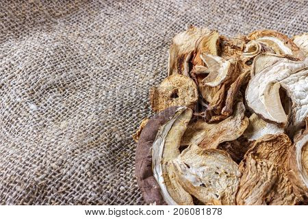 dried mushroom on sackcloth. Top view dried porcini mushrooms.