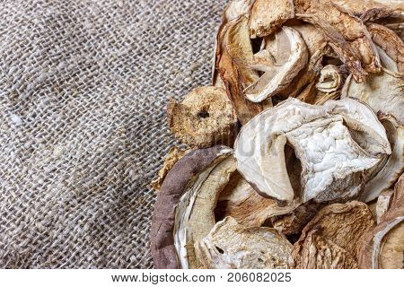dried porcini mushrooms on sackcloth. Top view.
