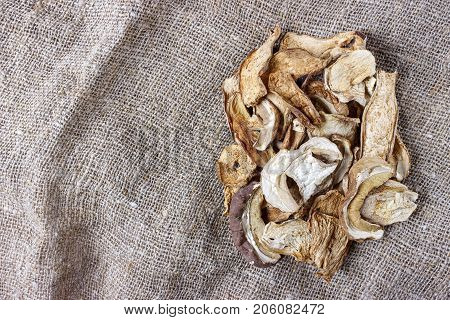 dried mushroom on sackcloth. Top view dried porcini mushrooms.