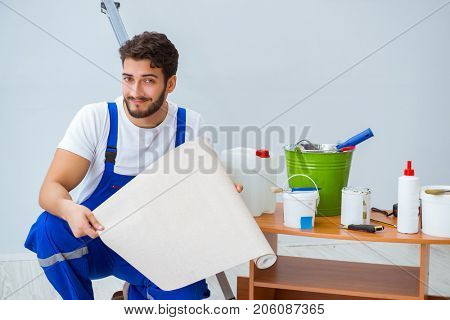 Repairman doing renovation repair in the house with paper wallpa