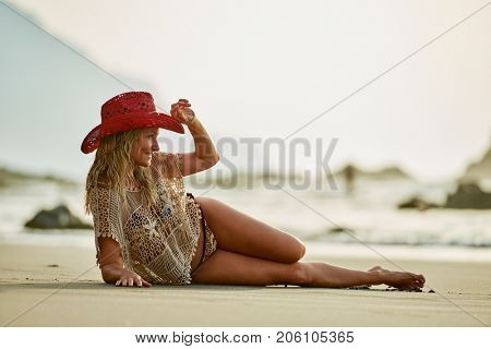 young woman relaxing on the beach in summer day