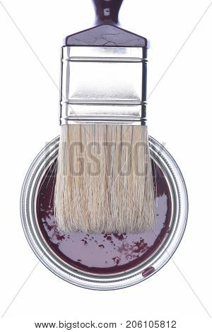 Top view of cherry paint can with paintbrush isolated on white background