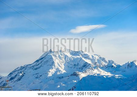 Alpine winter mountain landscape. French Alps covered with snow in sunny day. Val-d'Isere, France