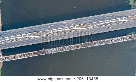 Aerial top view of bridge road automobile traffic of cars and railroad from above, transportation concept