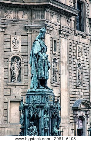 Old statue of Charles IV and St. Francis of Assissi church Prague Czech republic. Blue photo filter. Architectural theme.