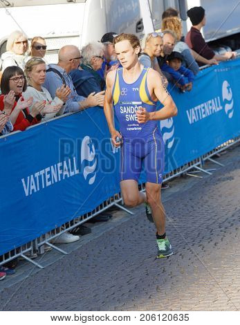 STOCKHOLM - AUG 26 2017: Running triathlete Gabriel Sandor (SWE) at the finish audience clapping hands in the Men's ITU World Triathlon series event August 26 2017 in Stockholm Sweden