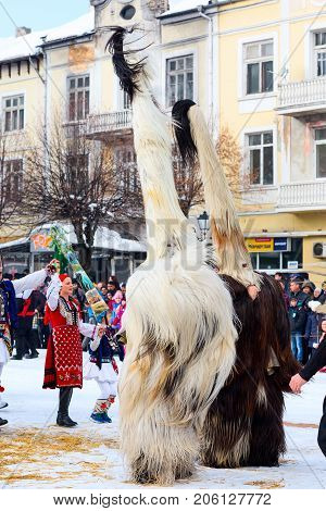 Razlog, Bulgaria - January 14, 2017: People in traditional carnival kuker costumes at Kukeri festival Starchevata