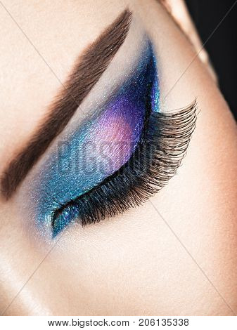  woman's eye with blue eye makeup