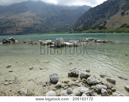 Stones in a Sea with mountains in the background
